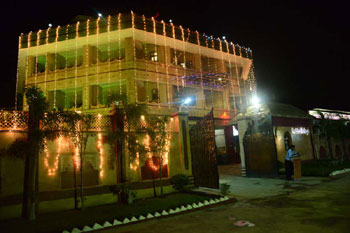 Hotel exterior lit up at night with fairy lights